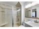 Bathroom featuring a tile shower with a glass door and a vanity with granite countertop at 705 Berry Ct, Villa Rica, GA 30180