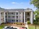Multi-story building with multiple balconies, lakeside community, and well-maintained landscaping at 705 Berry Ct, Villa Rica, GA 30180