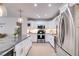 Bright kitchen with stainless steel appliances, white cabinets, granite countertops, recessed lighting, and hardwood flooring at 705 Berry Ct, Villa Rica, GA 30180