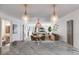A granite kitchen island overlooks the dining and living areas, offering seamless flow and abundant natural light at 705 Berry Ct, Villa Rica, GA 30180