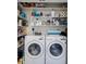 Efficient laundry closet with washer, dryer, and shelving for organized storage solutions at 705 Berry Ct, Villa Rica, GA 30180