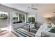 Bright living room with water views, neutral walls, ceiling fan, and access to the outside deck at 705 Berry Ct, Villa Rica, GA 30180