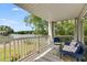 Relaxing screened patio with furniture and a scenic view of the lake and lush greenery at 705 Berry Ct, Villa Rica, GA 30180