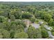 Residential neighborhood surrounded by dense greenery with a mix of houses and tree coverage at 9760 Loblolly Ln, Roswell, GA 30075