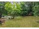Lush backyard with mature trees, stone landscaping, and a serene setting for relaxation at 9760 Loblolly Ln, Roswell, GA 30075