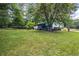 Spacious backyard with well-maintained lawn, mature trees, and a charming screened porch at 9760 Loblolly Ln, Roswell, GA 30075