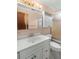 Functional bathroom featuring a vanity with ample storage, a mirrored cabinet, and a shower at 9760 Loblolly Ln, Roswell, GA 30075