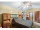 Bedroom with ceiling fan, built-in storage, and a connecting door to the bathroom at 9760 Loblolly Ln, Roswell, GA 30075
