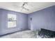 Simple bedroom with window for natural light. Blue walls and base trim add a minimalist touch at 9760 Loblolly Ln, Roswell, GA 30075