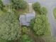 Overhead view of home with grey roof and fenced yard shaded by mature trees at 9760 Loblolly Ln, Roswell, GA 30075