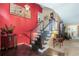 Inviting foyer with decorative staircase, red accent wall and tile flooring at 9760 Loblolly Ln, Roswell, GA 30075