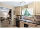 Inviting kitchen with granite countertops, stainless steel appliances, and view to the living room at 9760 Loblolly Ln, Roswell, GA 30075