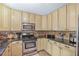 Charming kitchen with granite countertops, stainless steel appliances, and custom cabinetry at 9760 Loblolly Ln, Roswell, GA 30075