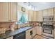 Well-lit kitchen with granite countertops, stainless steel appliances, and a view to the yard at 9760 Loblolly Ln, Roswell, GA 30075