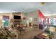 Cozy living room with stone fireplace, plush seating, and adjacent dining area at 9760 Loblolly Ln, Roswell, GA 30075