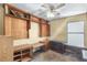 Office room features wooden shelving, multiple desks, and a window for plenty of natural light at 9760 Loblolly Ln, Roswell, GA 30075