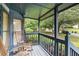 Inviting covered porch with rocking chairs and view of the landscaped front yard at 9760 Loblolly Ln, Roswell, GA 30075