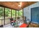 Relaxing screened porch with wood ceiling, comfortable seating, and views of the lush backyard at 9760 Loblolly Ln, Roswell, GA 30075