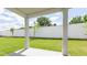 A covered back porch overlooks a large backyard with a white brick wall at 1818 Butterfly Way, Marietta, GA 30066
