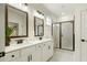 Bright bathroom featuring double sinks and a large shower with black trim at 1818 Butterfly Way, Marietta, GA 30066