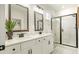 Bright bathroom featuring double sinks and a large shower with black trim at 1818 Butterfly Way, Marietta, GA 30066