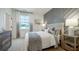 Comfortable bedroom featuring a decorative accent wall and natural light from the window at 1818 Butterfly Way, Marietta, GA 30066
