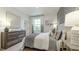 Comfortable bedroom featuring stylish gray accents, elegant lamps, and ample natural light at 1818 Butterfly Way, Marietta, GA 30066