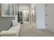 Hallway leading to a bathroom, featuring a bench seat and light gray walls at 1818 Butterfly Way, Marietta, GA 30066