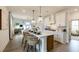 Bright kitchen with an eat-in island and white cabinets, adjacent to living and dining areas at 1818 Butterfly Way, Marietta, GA 30066