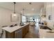 Open-concept kitchen boasts an eat-in island, and overlooks a dining and living area at 1818 Butterfly Way, Marietta, GA 30066