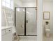 Beautiful shower featuring gray subway tile, a bench, and a black-trimmed glass door at 1818 Butterfly Way, Marietta, GA 30066