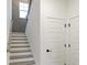 A view of the staircase with decorative wall trim and white paneled doors at 1818 Butterfly Way, Marietta, GA 30066