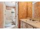 The bathroom is accented by orange-tinted walls, a tile counter, and a bathtub at 3299 Pete Shaw Rd, Marietta, GA 30066
