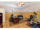 A bedroom offering laminated floor, ceiling fan, desk and exercise equipment at 3299 Pete Shaw Rd, Marietta, GA 30066