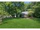A well-manicured lawn and mature trees surround this attractive single-story home at 3299 Pete Shaw Rd, Marietta, GA 30066