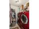 The laundry room is stocked with a red washer and dryer and metal shelving at 3299 Pete Shaw Rd, Marietta, GA 30066