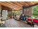 The sunroom features wood-paneled walls and ceiling, brick flooring, and natural light at 3299 Pete Shaw Rd, Marietta, GA 30066