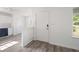 Bright entryway featuring modern gray flooring, white walls, and partial view of the kitchen at 3645 Ten Oaks Cir, Powder Springs, GA 30127