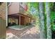 Backyard with patio and wooden deck, surrounded by mature trees at 4905 Village Green Dr, Roswell, GA 30075