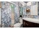 Charming bathroom featuring blue and white patterned wallpaper, a sliding glass shower door and custom vanity at 4905 Village Green Dr, Roswell, GA 30075