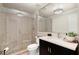 Modern bathroom featuring a glass enclosed shower and dark vanity with a white countertop at 4905 Village Green Dr, Roswell, GA 30075