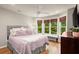 Cozy bedroom with large windows, neutral tones, and comfortable furnishings, creating a relaxing space at 4905 Village Green Dr, Roswell, GA 30075