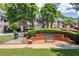 Charming community seating area with a bench surrounded by manicured landscaping and brick accents at 4905 Village Green Dr, Roswell, GA 30075