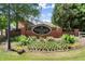 Welcoming Heritage at Roswell community sign surrounded by vibrant landscaping and manicured greenery at 4905 Village Green Dr, Roswell, GA 30075