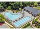 Aerial view of a sparkling community pool area with lounge chairs and well-maintained landscaping at 4905 Village Green Dr, Roswell, GA 30075
