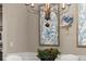Dining area featuring decorative blue artwork, a chandelier, and neutral wall colors at 4905 Village Green Dr, Roswell, GA 30075
