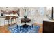 Cozy dining area with a round table, striped chairs, and blue decorative accents at 4905 Village Green Dr, Roswell, GA 30075