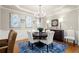 Charming dining room with decorative blue artwork, a chandelier, and a round wood table at 4905 Village Green Dr, Roswell, GA 30075