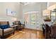 Bright foyer with hardwood floors, stylish furniture, and a decorative doorway to the outdoors at 4905 Village Green Dr, Roswell, GA 30075