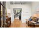 Bright foyer boasts hardwood floors, wainscoting, high ceilings, and decorative furnishings at 4905 Village Green Dr, Roswell, GA 30075